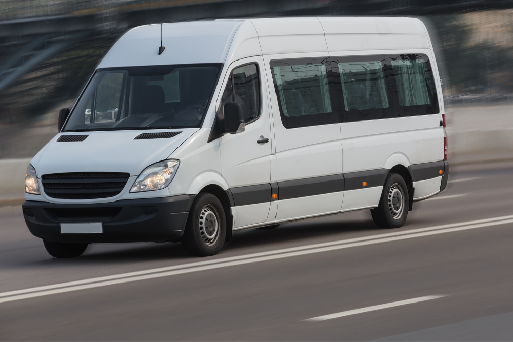 White paratransit van driving